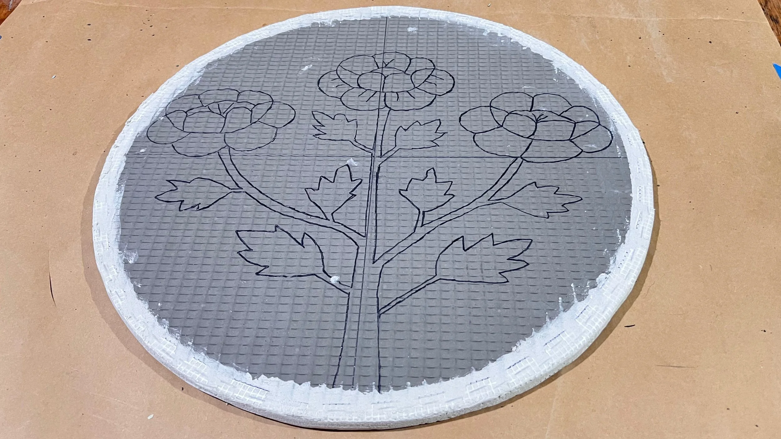 Completed Wedi board circle with fiberglass mesh and mortar edging, ready for mosaic installation for the Cycles public art commission by Dyanne Williams