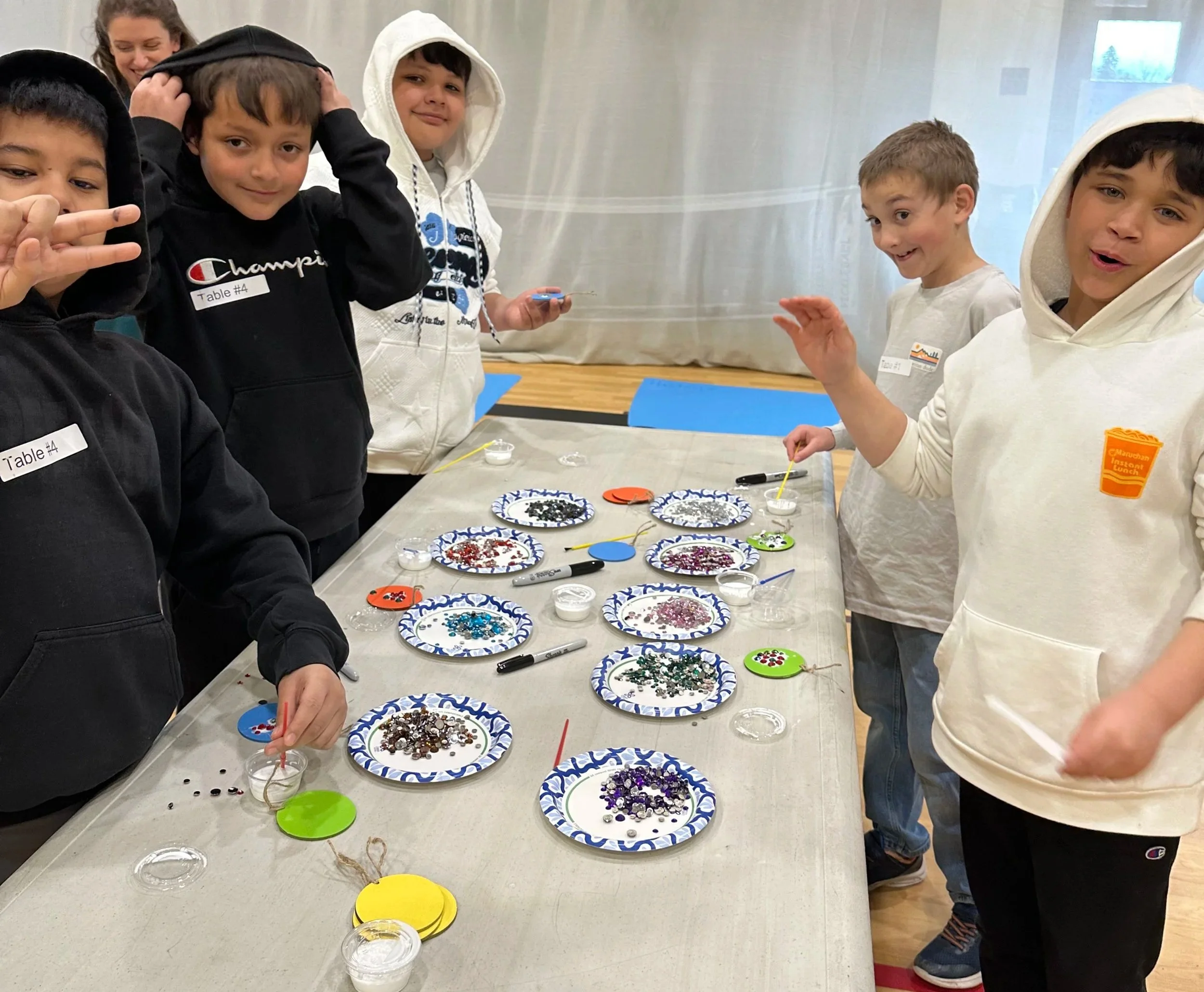 Students creating a gem mosaic medallion during the Cycles public art commission participation project at Ida Nason Aronica Elementary School in Ellensburg, Washington