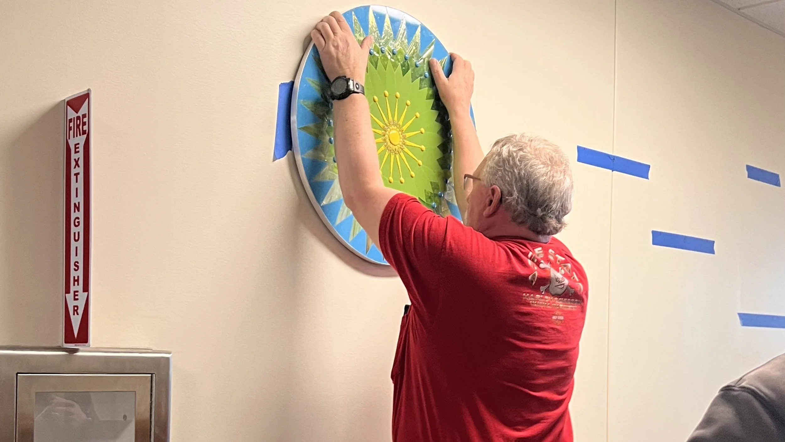 Head custodian installing the first Cycles public art mosaic panel at Ida Nason Aronica Elementary School in Ellensburg, Washington