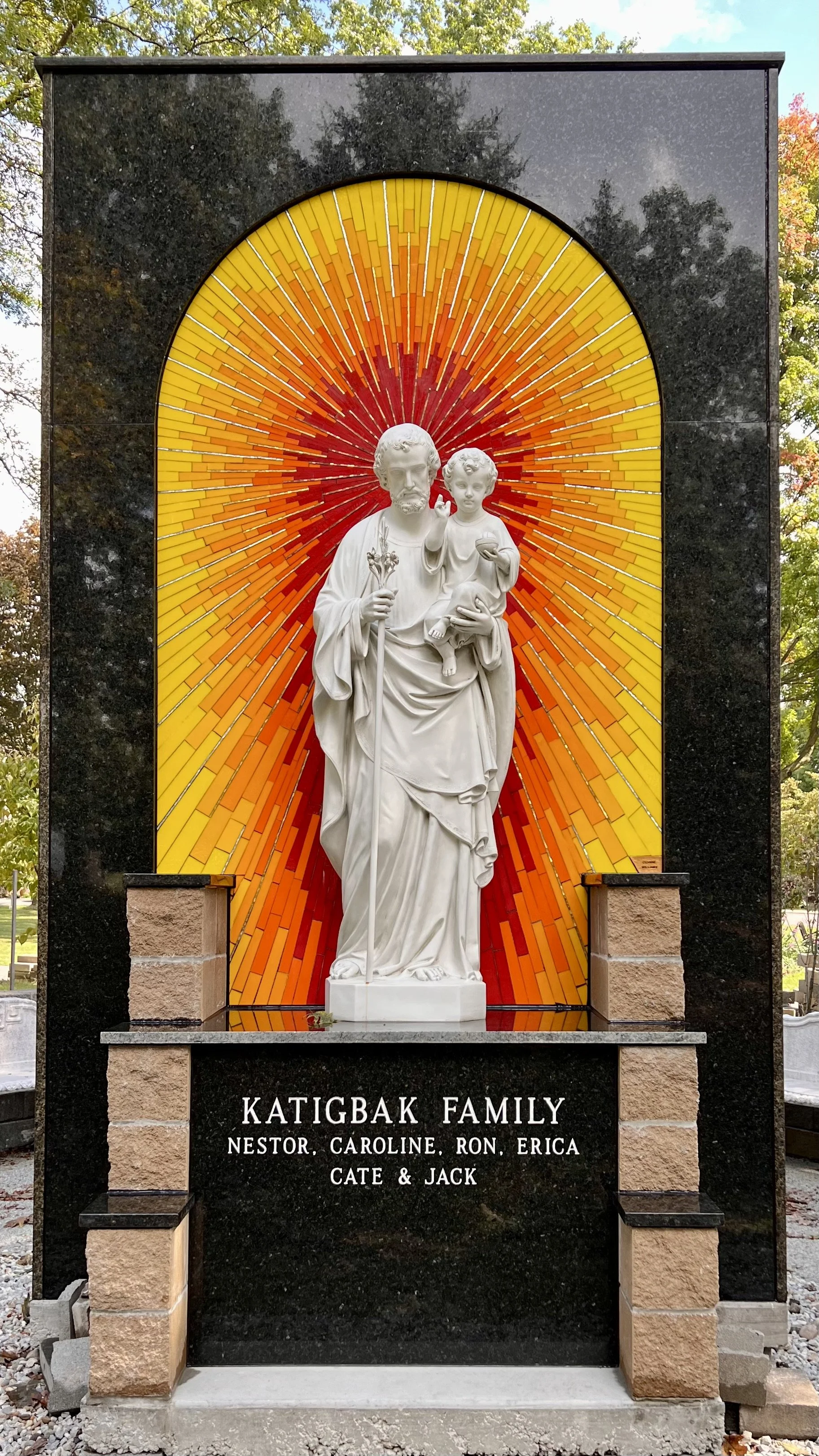 Completed Sancta Clara Sunrise Mosaic with stained glass and smalti behind a statue of St. Joseph