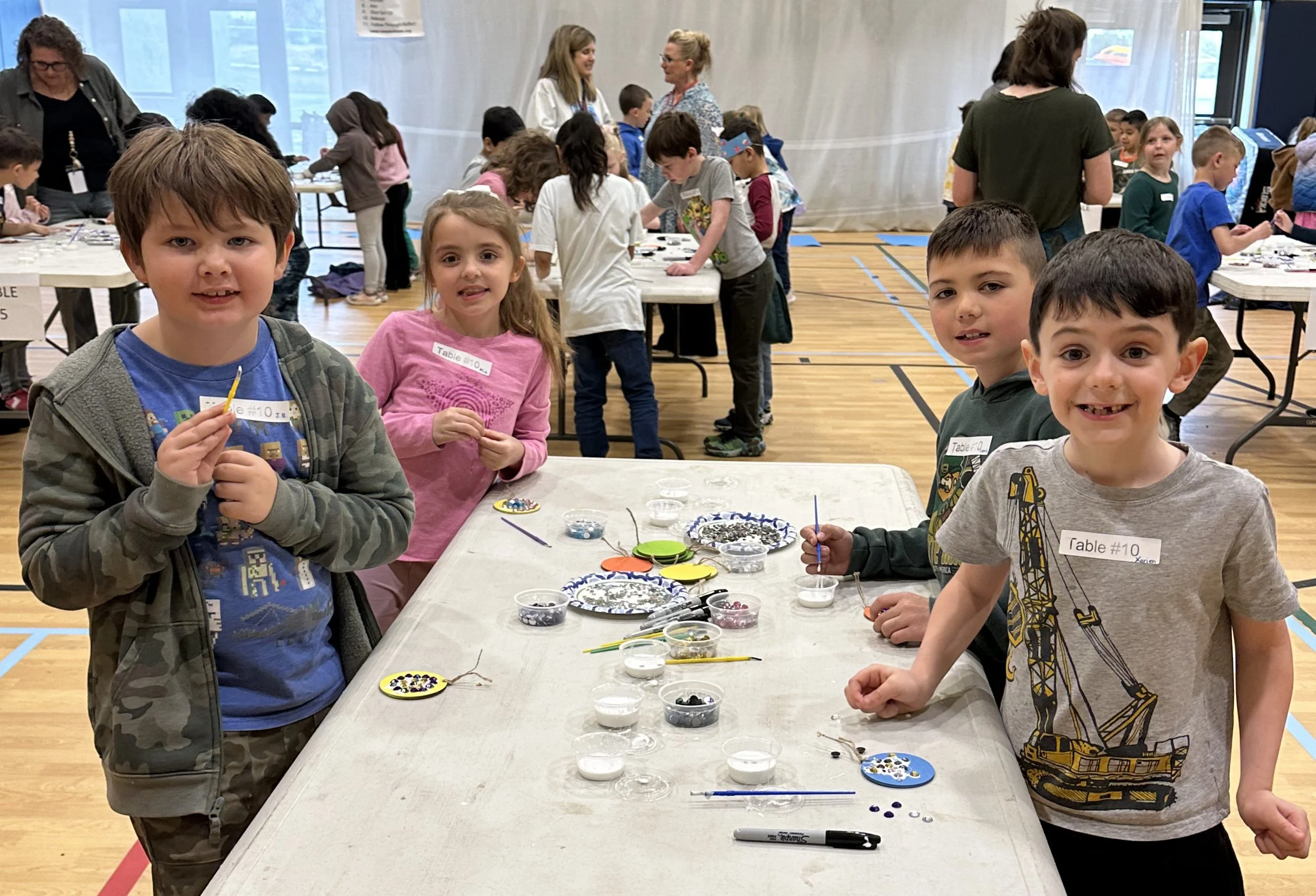 Students creating a gem mosaic medallion during the Cycles public art commission participation project at Ida Nason Aronica Elementary School in Ellensburg, Washington