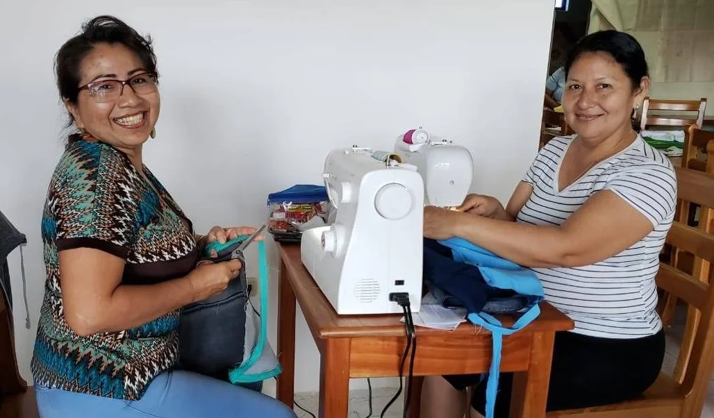 Sewing the reusable bags is a team effort.