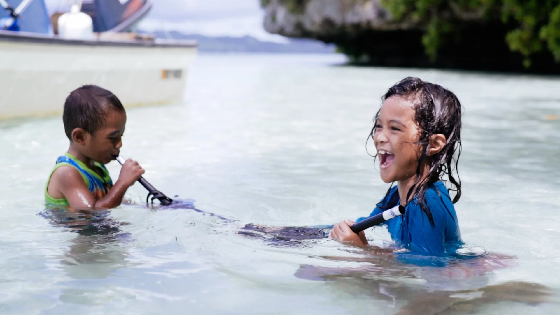 Children playing in the ocean, Palau.