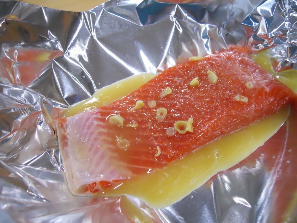 Add the butter, honey and garlic mixture to the salmon and make sure it's well coated.