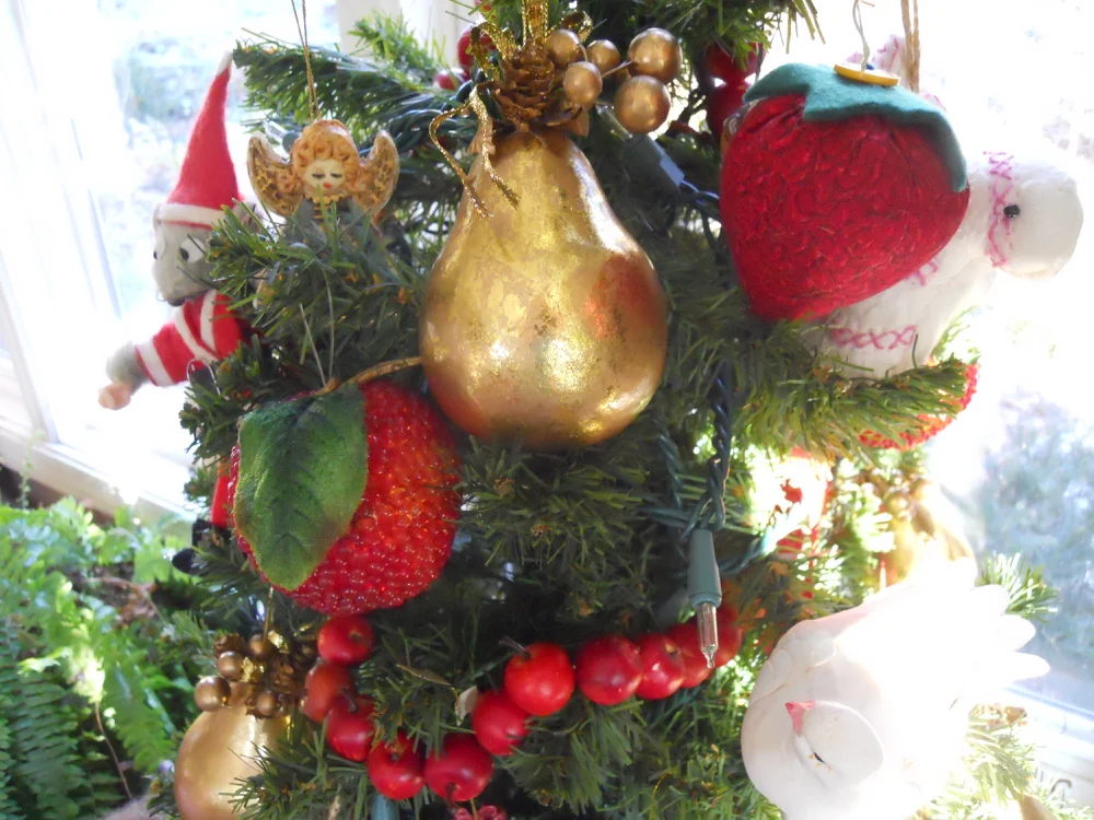Fabric strawberry pincushions add a touch of family heritage to my Christmas tree.