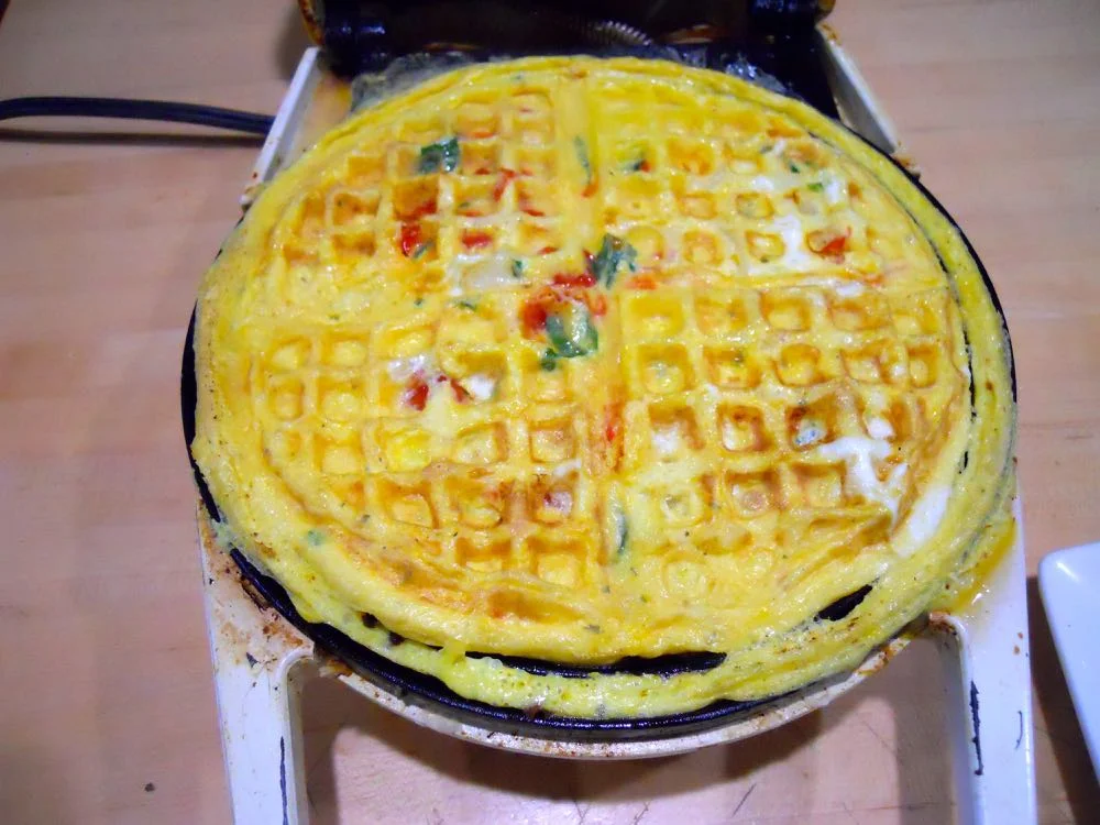 Cooking in my mother's old waffle iron almost ready to remove. Let it sit for a few seconds first.