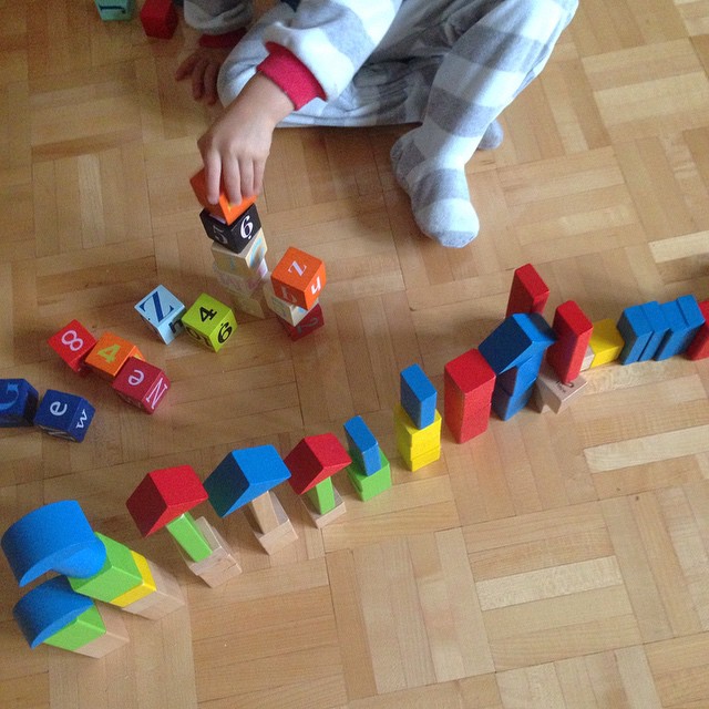 little boy playing with wooden blocks.jpg