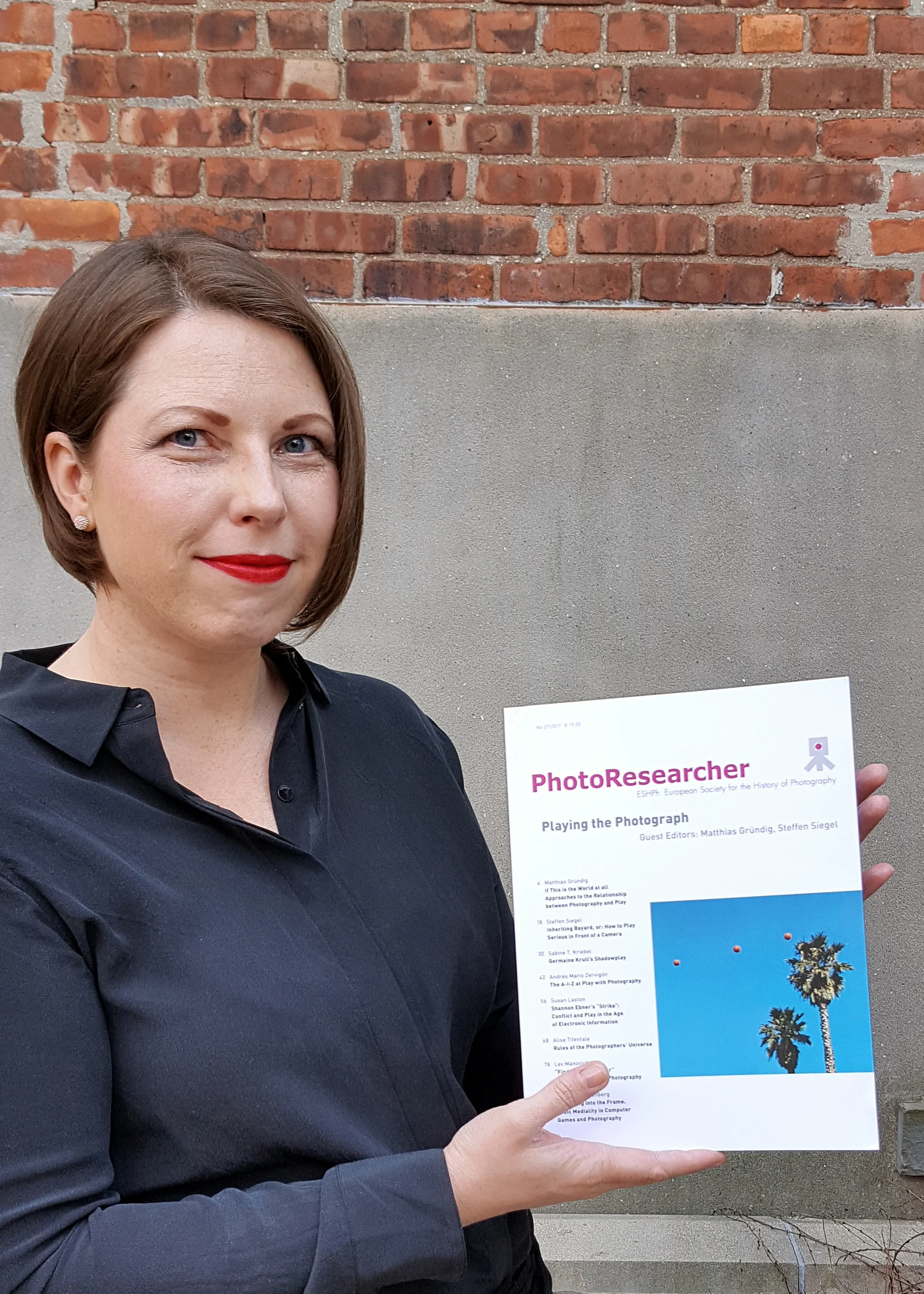 Alise Tifentale with the April 2017 issue of Photoresearcher which features article " Rules of the Photographers' Universe ." Photo: Hon Sun Lam.