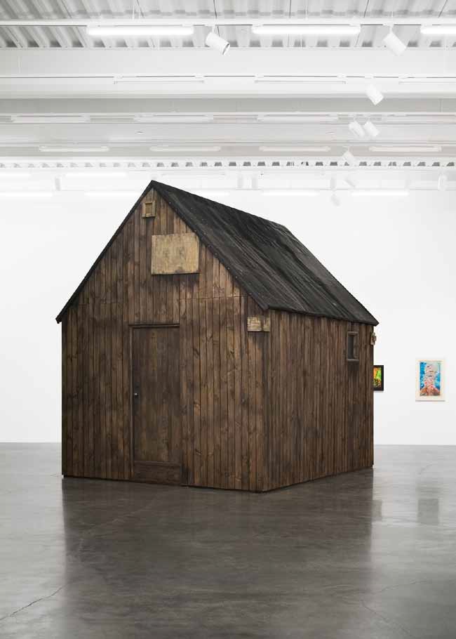 Robert Kusmirowski, Unacabine, 2008. Wooden boards, tar paper, plywood, tin pipe, oil, acrylic. 398 x 322 x 355 cm. Courtesy of Foksal Gallery Foundation, Warszawa and New Museum, New York. Photo by Benoit Pailley.