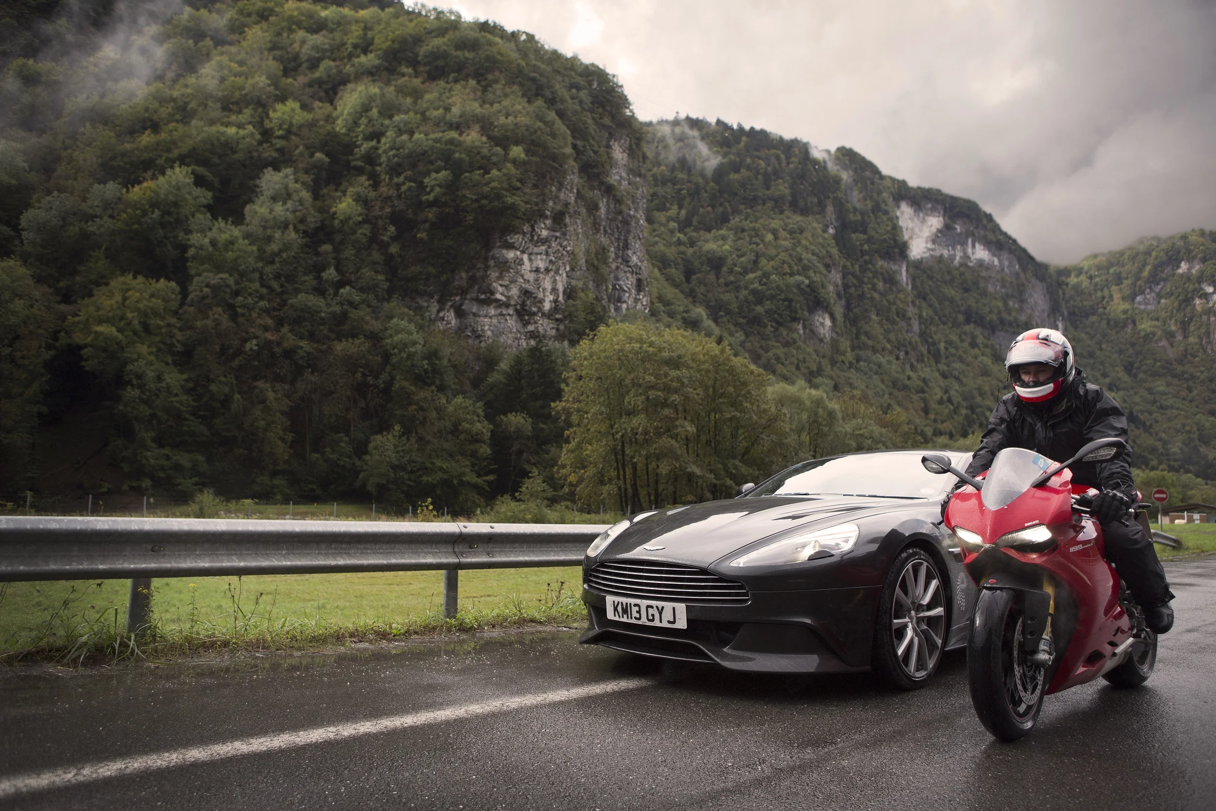 Ep1&2 Russ riding the Ducati Panigale next to the Aston Martin Vanquish.jpg