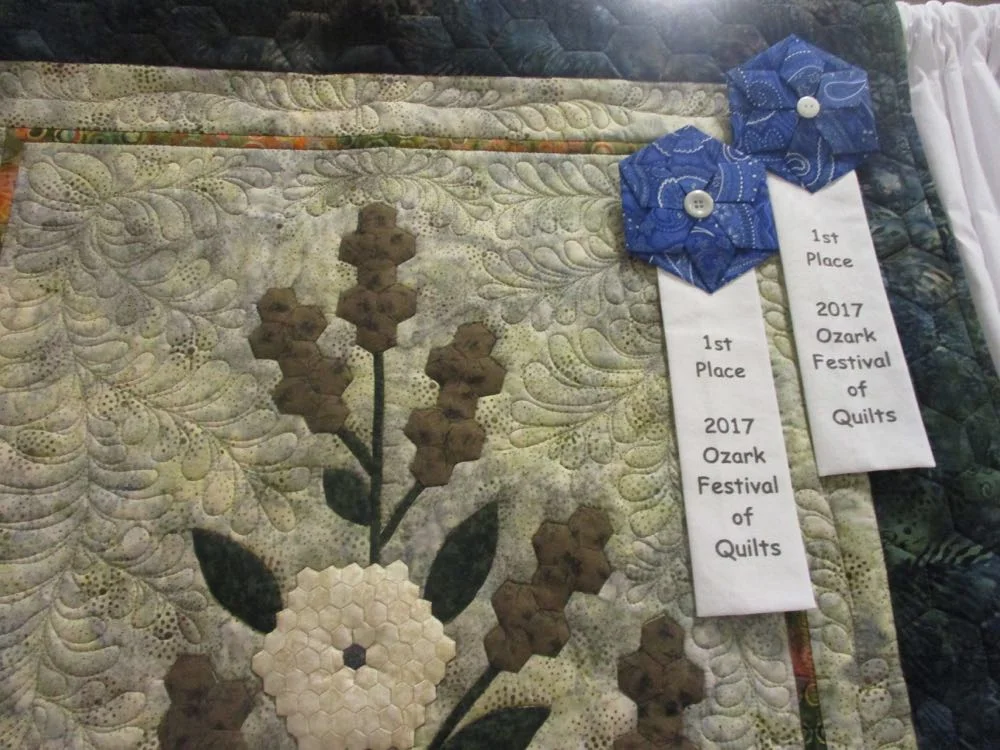 Cattails and chrysanthemums are made out of individual hexagon patchwork pieces.