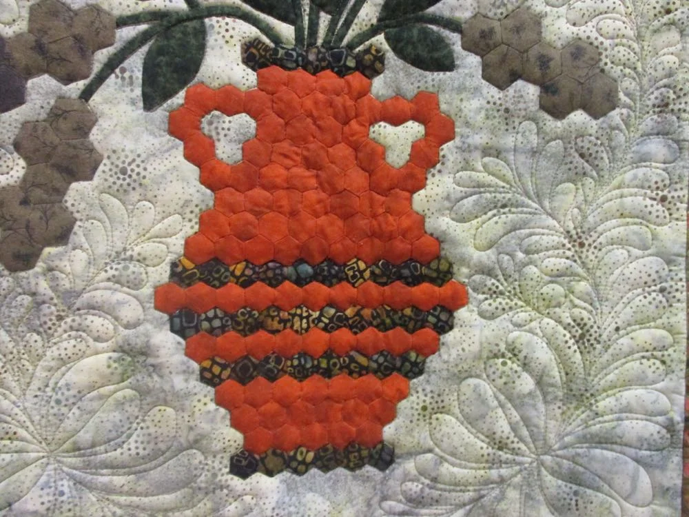 Look at the detail work in the orange vase that holds the cattails and chrysanthemums.