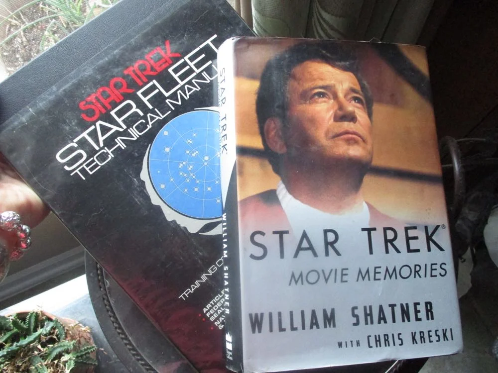 Two autographed Star Trek books are currently up for auction on Ebay.
