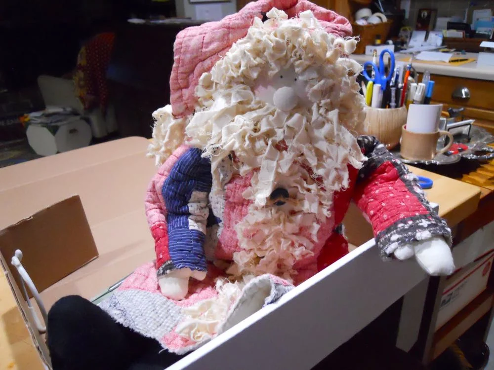 The first handmade quilt Santa doll getting ready to travel to his new home.