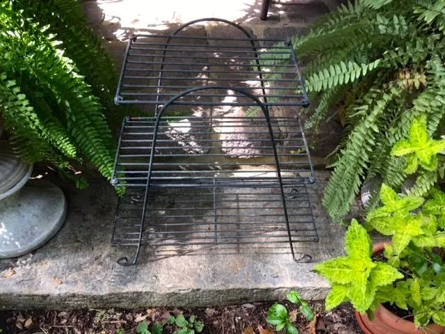 One of the pre-used wire plant stands I re-purposed into an outside side table with plexiglass.