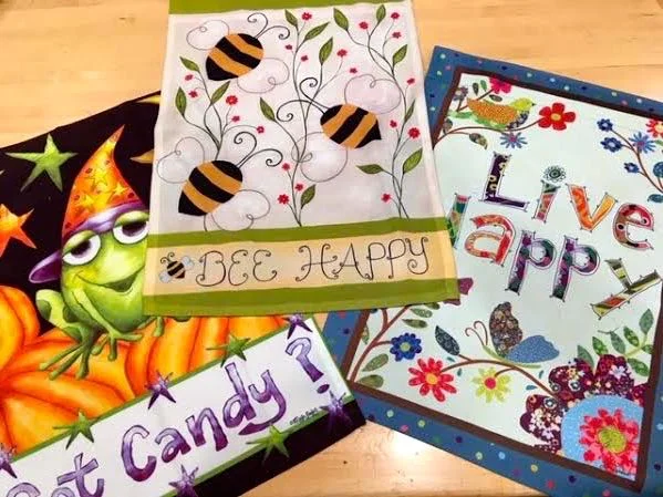 Garden flags with funny and uplifting messages. (Photo by Charlotte Ekker Wiggins)