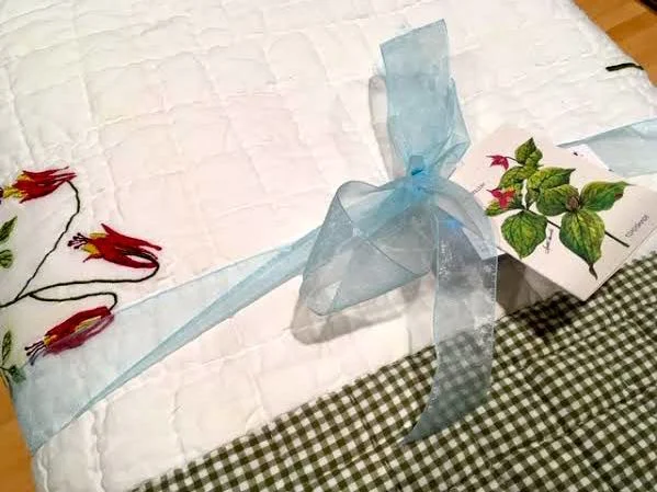 A fun touch with this gift quilt, the gift tag matches! (Photo by Charlotte Ekker Wiggins)