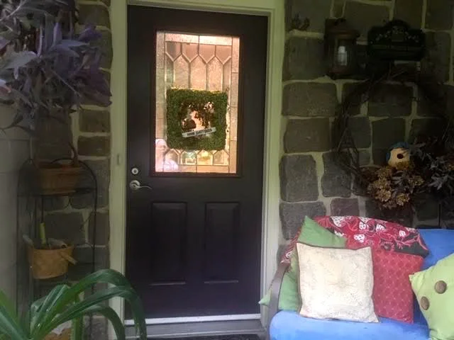 My “new” square green door wreath fits in nicely on my front deck. (Photo by Charlotte Ekker Wiggins)