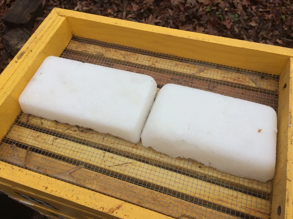 Emergency sugar cakes formed in bread pans nicely fit across my honeybee hives.