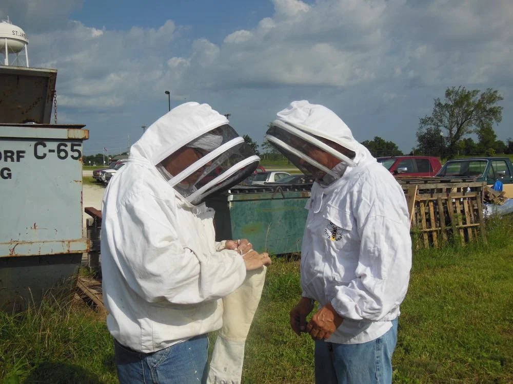 The president of the company where we were removing the bees suits up to lend a hand.