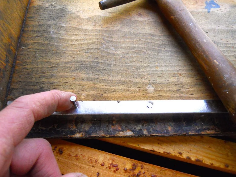 Hammering the tiny nails into the thin metal frames is easy once you figure out how to set it up.