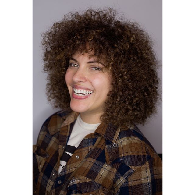 I hope all my clients leave my chair this happy! 
I took off several inches of length, graduating the sides, rounding out the top and giving her some fringe. I love working with curly hair!