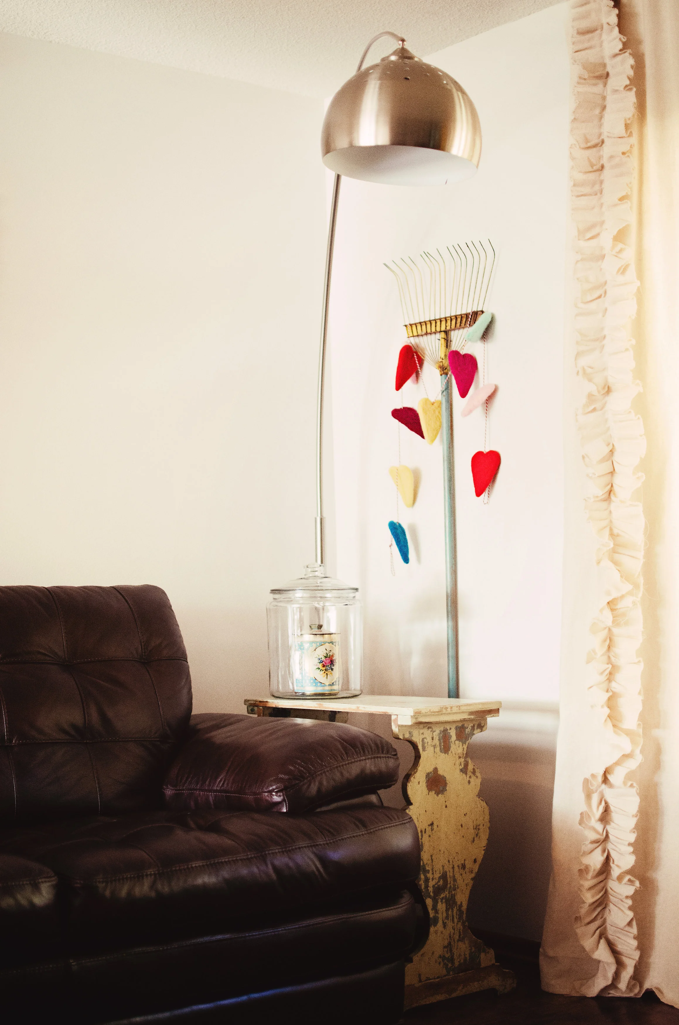 Modern overhead lamp, and a vintage rake as wall decor. H.Prall & Co. | hprallandco.com