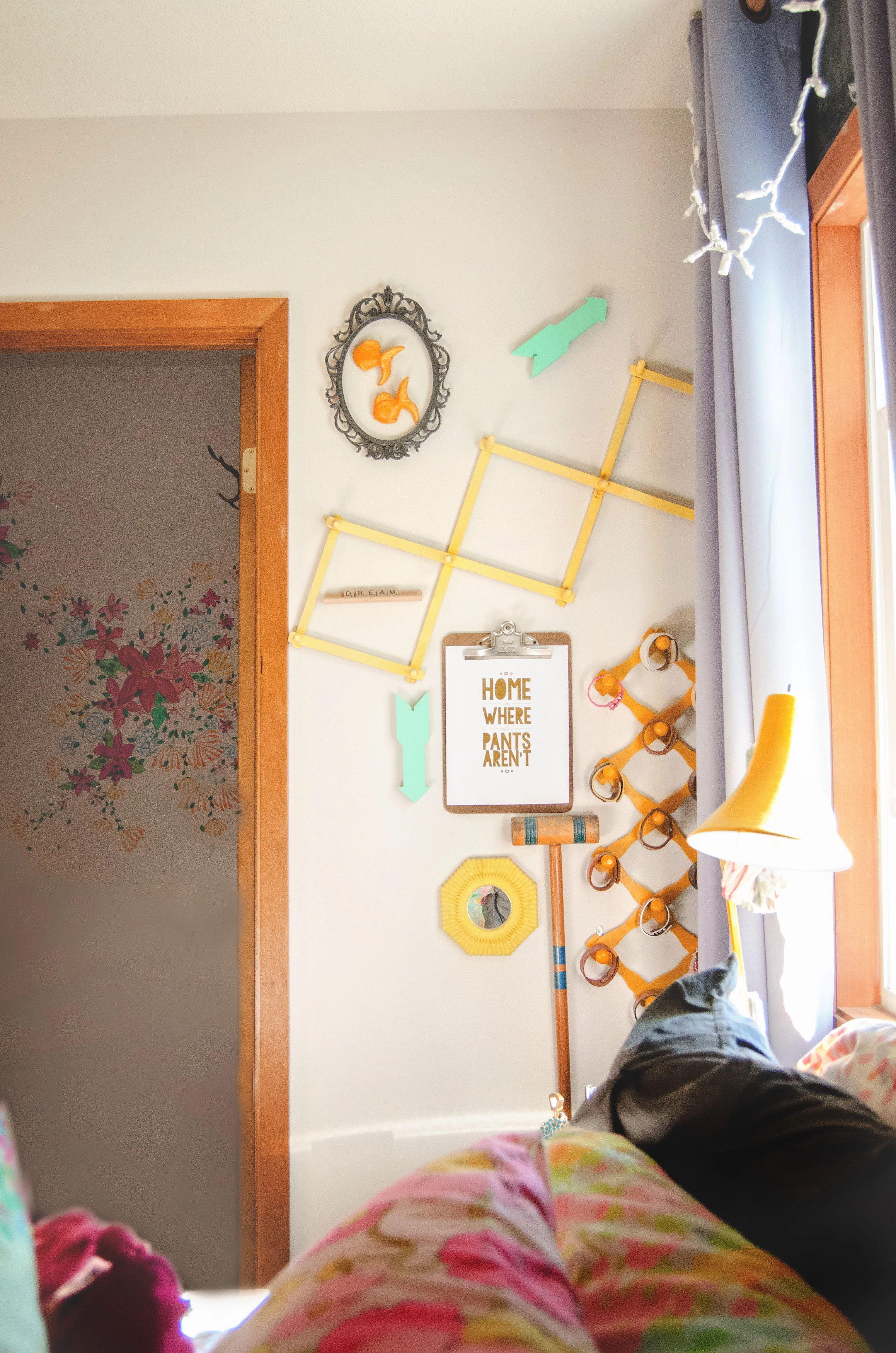 Vintage coat hanger painted yellow and used in a gallery wall layout. | hprallandco.com