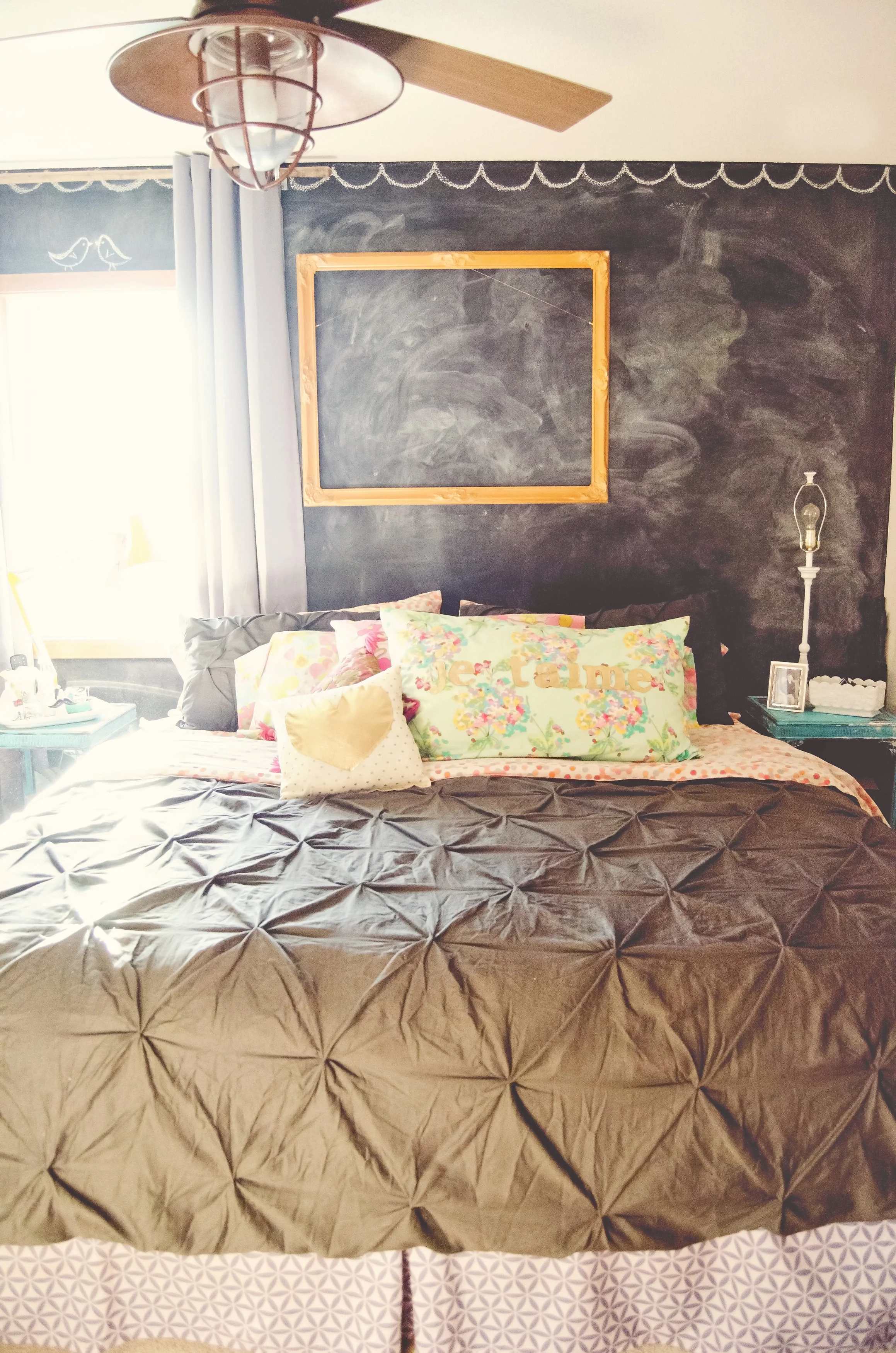 Chalkboard wall as a headboard with an empty yellow frame. | hprallandco.com