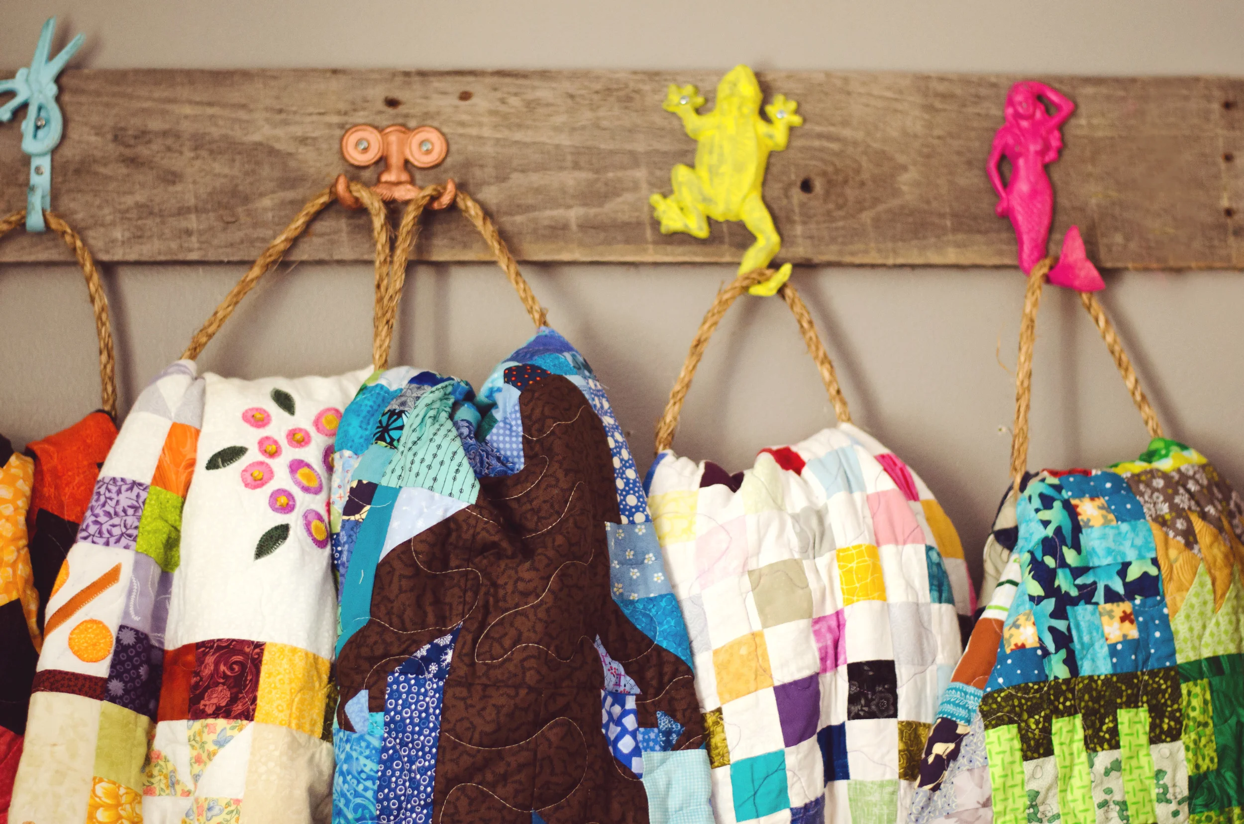 Colorful hooks to hold quilts. | hprallandco.com