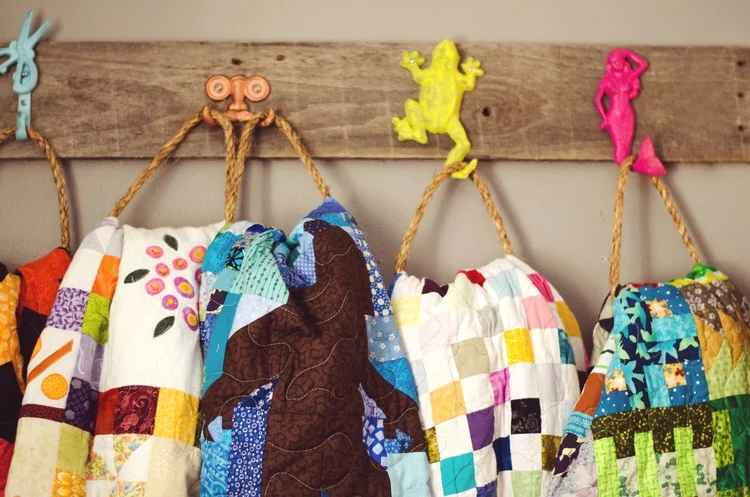 Colorful hooks to hang bright, colorful quilts. || RustopiaConsulting.com