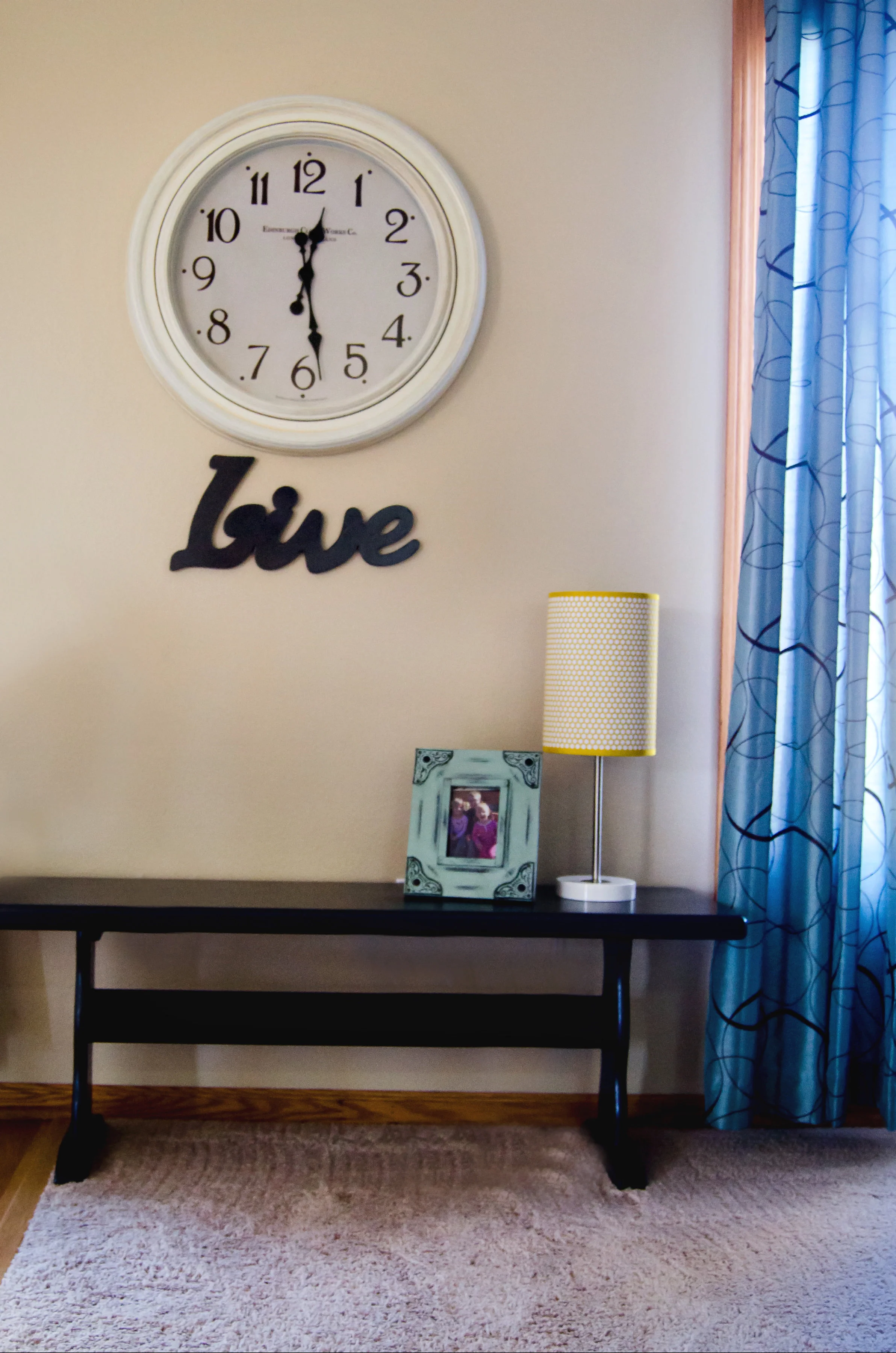 Wall clock, typography sign, over an entryway bench. | hprallandco.com
