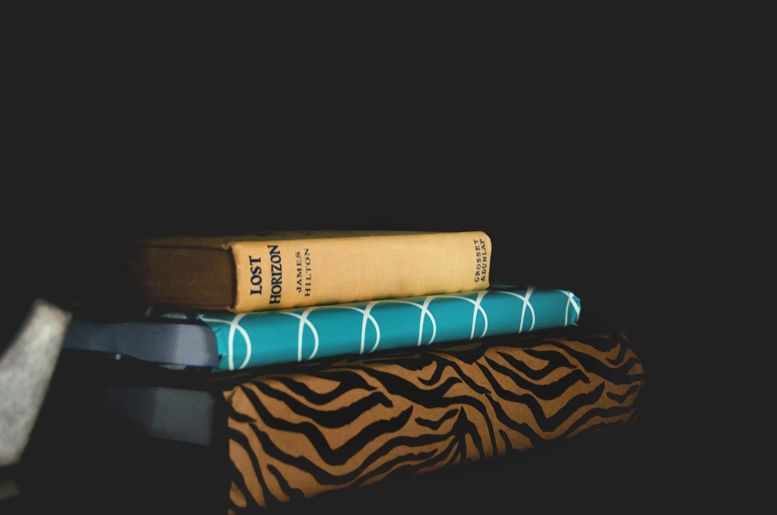 Stack of books wrapped in decorative paper. | hprallandco.com