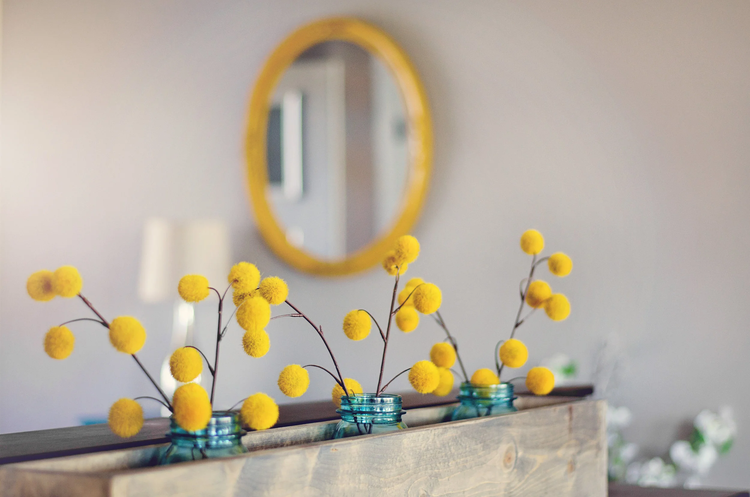 Yellow flowers in blue ball jars. H.Prall & Co. | hprallandco.com