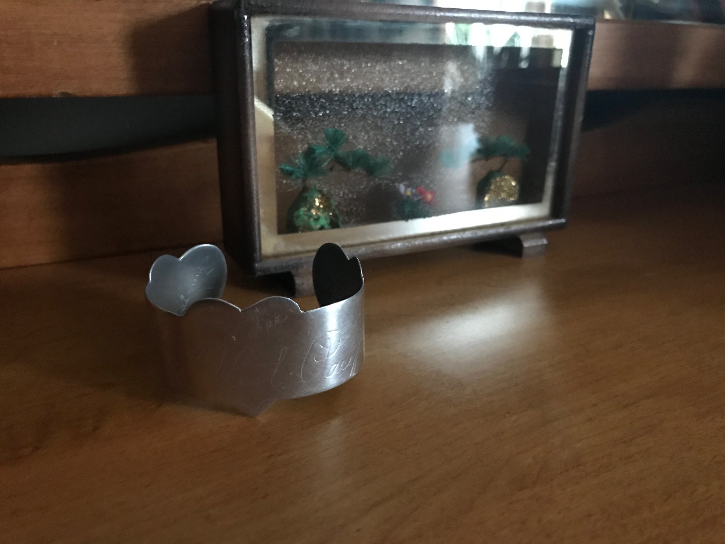 Estate sale bracelet. It's hard to see, but there are two names inscribed on this bracelet: Bob and Lila. It also has the name of the island where he was stationed in the South Pacific during WWII. It isn't an expensive piece by any means, but it is entirely priceless. 