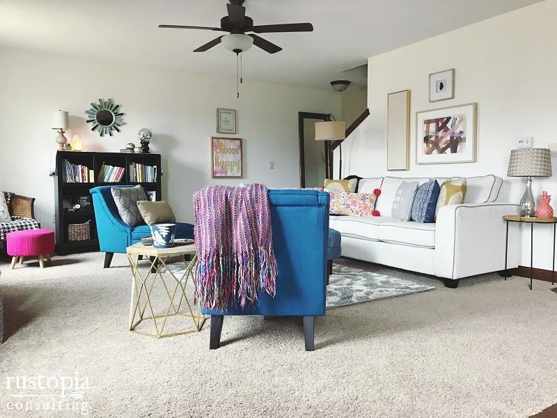 Living room design with blue accent chairs, and colorful throw pillows. | RustopiaConsulting.com