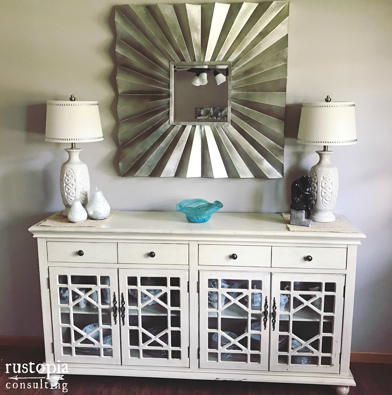 Cream colored buffet with matching lamps, and a large square mirror. | RustopiaConsulting.com