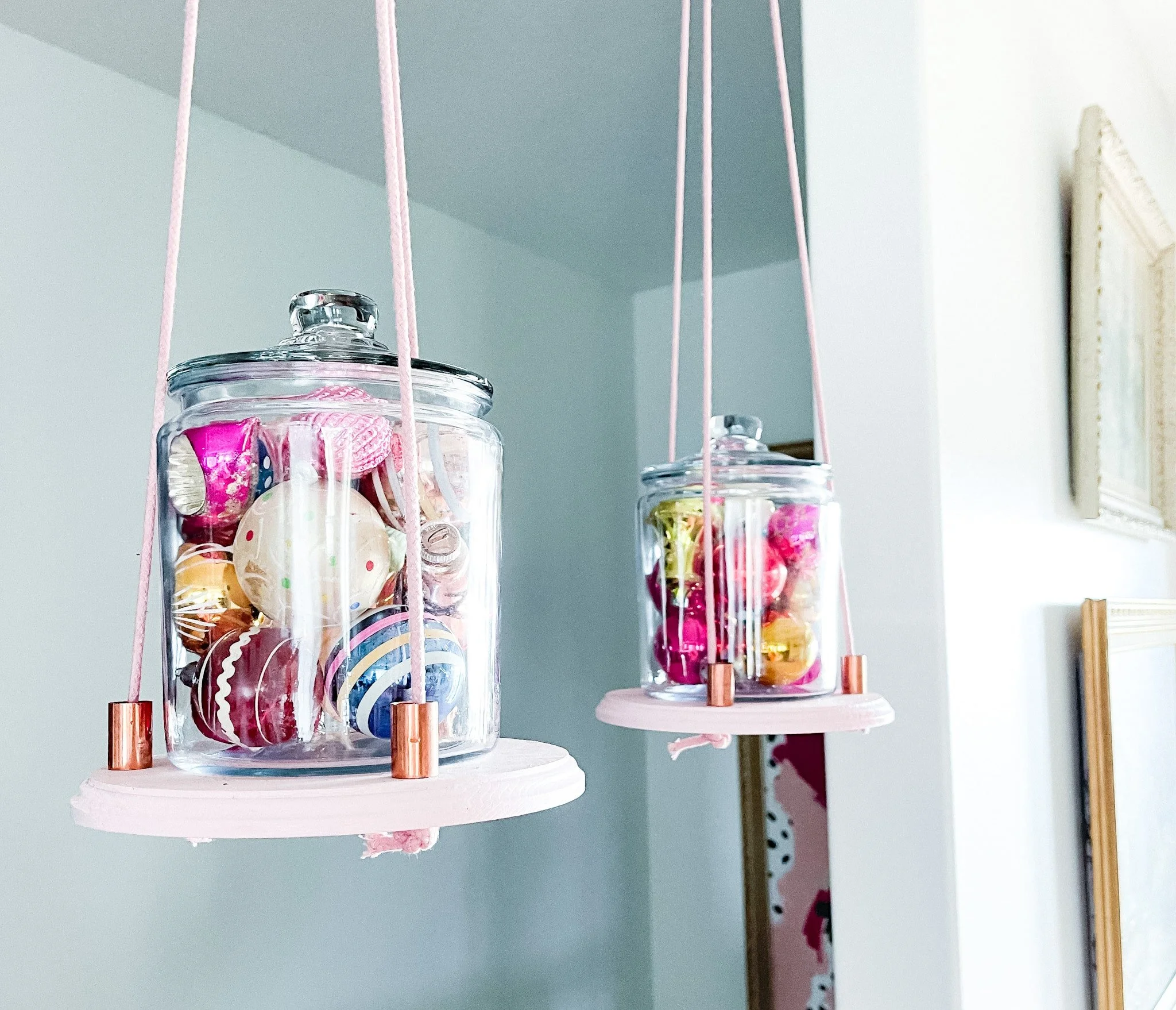Vintage mercury glass and Shiny Brite ornaments in glass canisters.
