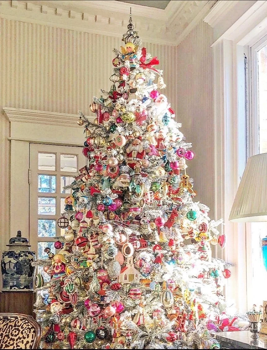 Flocked Christmas tree completely covered in vintage mercury glass and Shiny Brite ornaments.