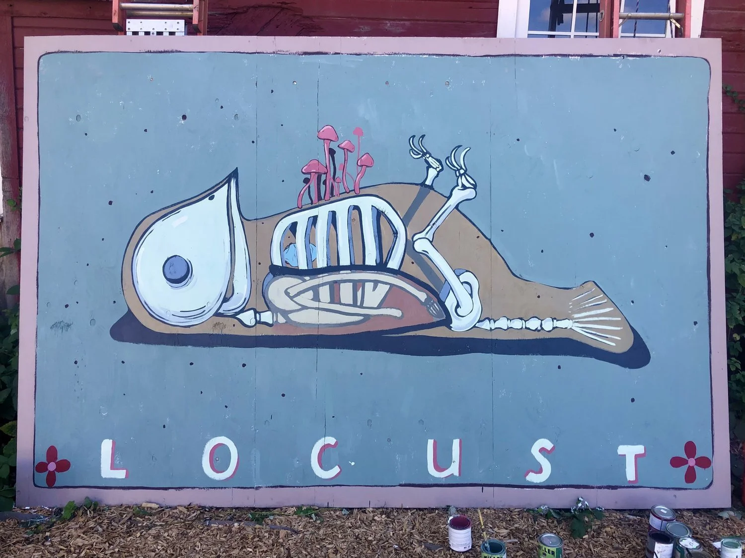 A painted illustration of a fish skeleton with pink mushrooms growing on its head, and the word 'LOCUST' written at the bottom.