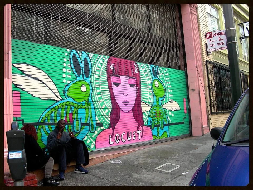 Street mural featuring a pink-haired girl with closed eyes, labeled 'LOCUST,' flanked by two stylized green insects with wings, on a green background.