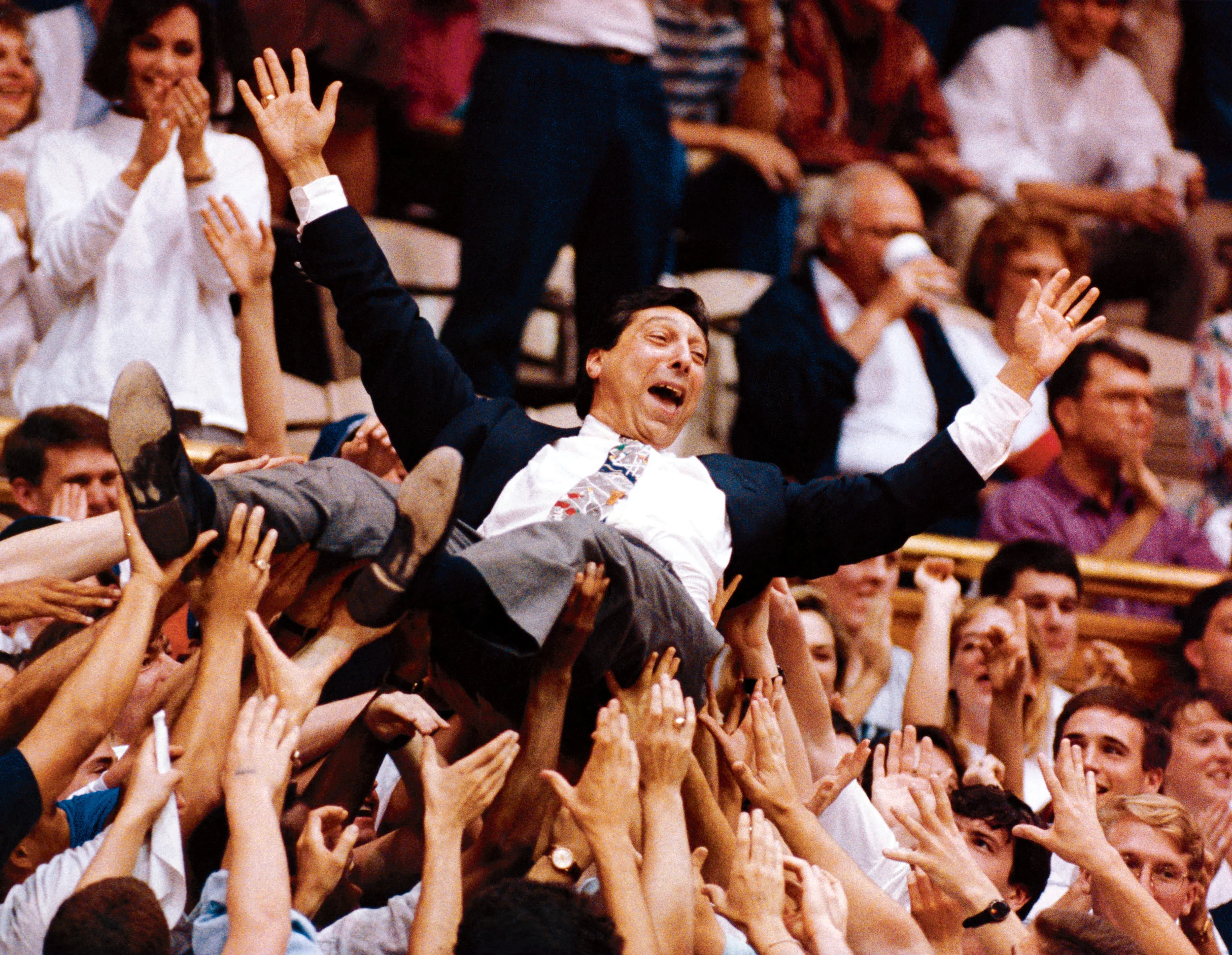 Valvano crowdsurfs while announcing a game in the early 1990s.