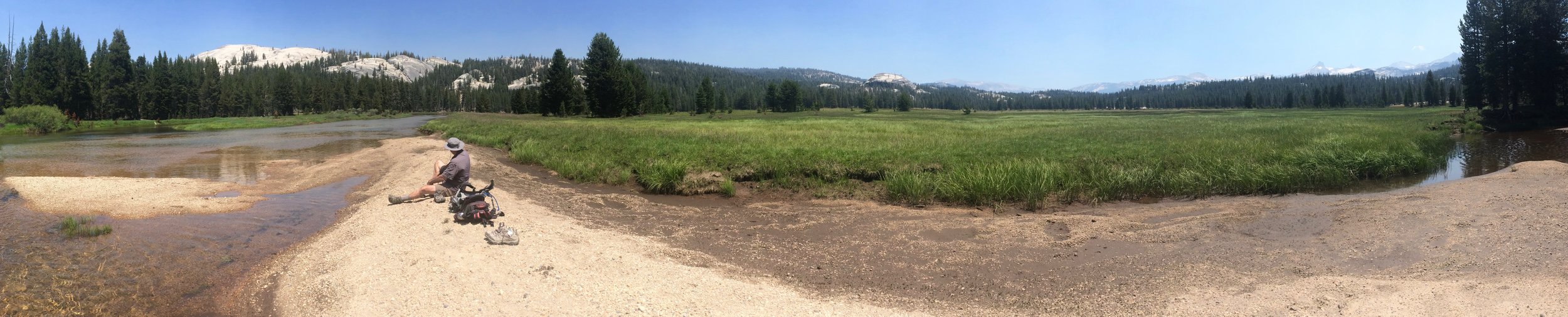 Sitting on a sand bar along the river. 