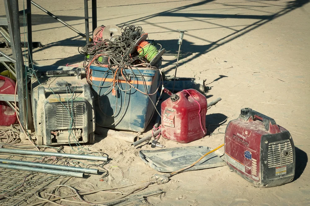 Gasoline on the playa is programatic. When spilled it makes one heck of a mess. Earth Guardians remind people to keep their gas cans safely contained and away from the generator. 