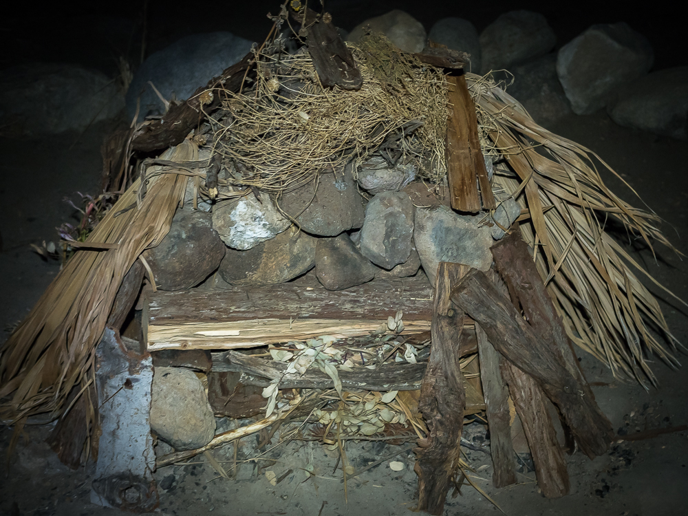 Rocks within; cedar wood and kindeling ready for burning.