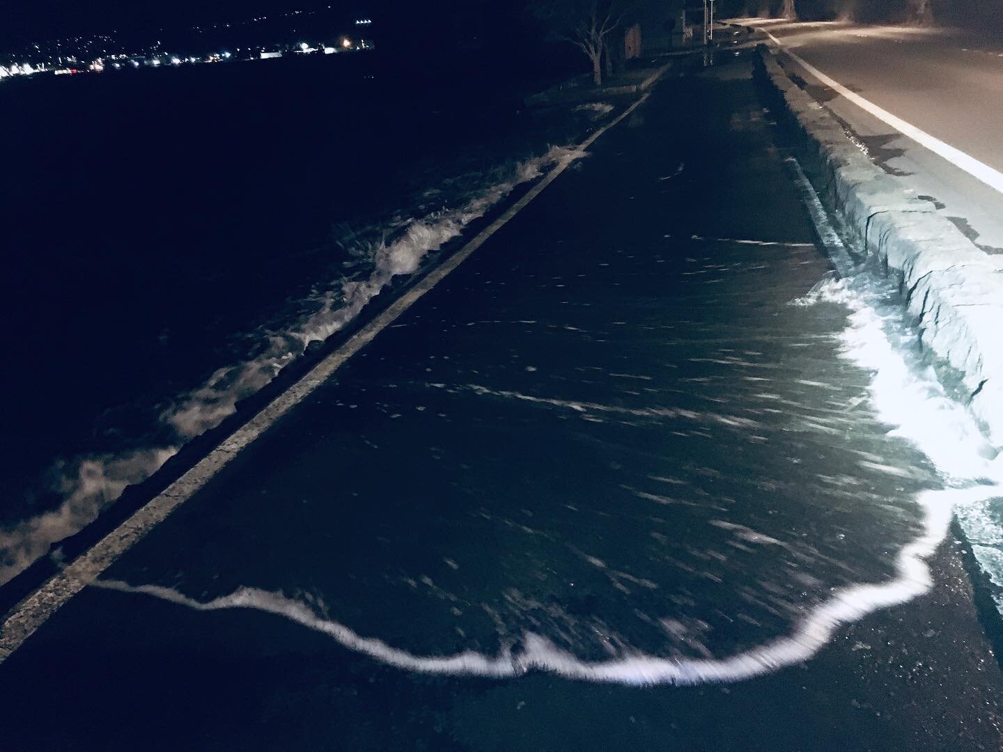 There&rsquo;s a storm tide and a mean warm westerly tail wind turbo boost, the harbour is all over the edge and the lights are out on the causeway. It feels dramatic. Had to hose down the bike. Haven&rsquo;t seen it quite like this before