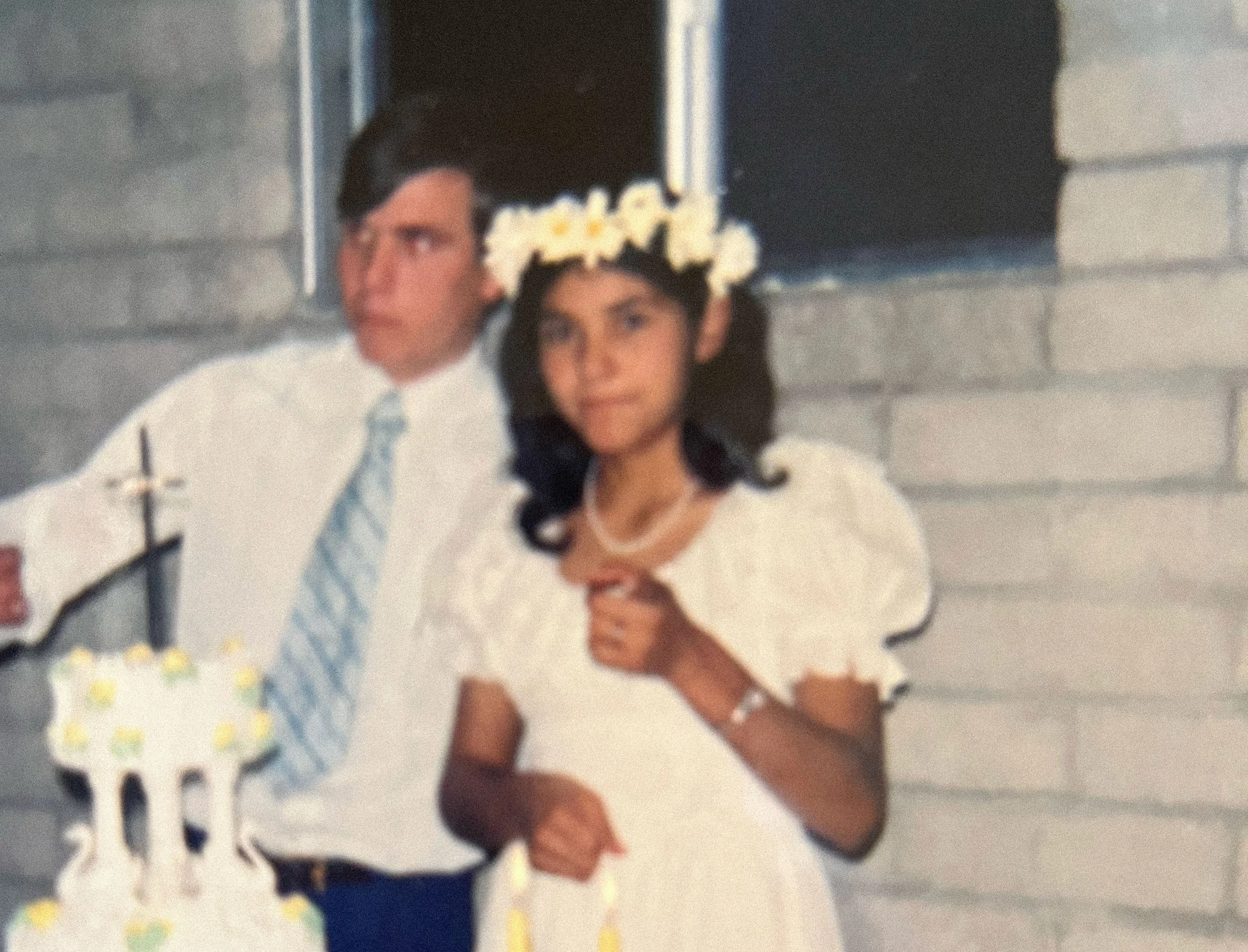 Vintage wedding photo of couple eating cake.