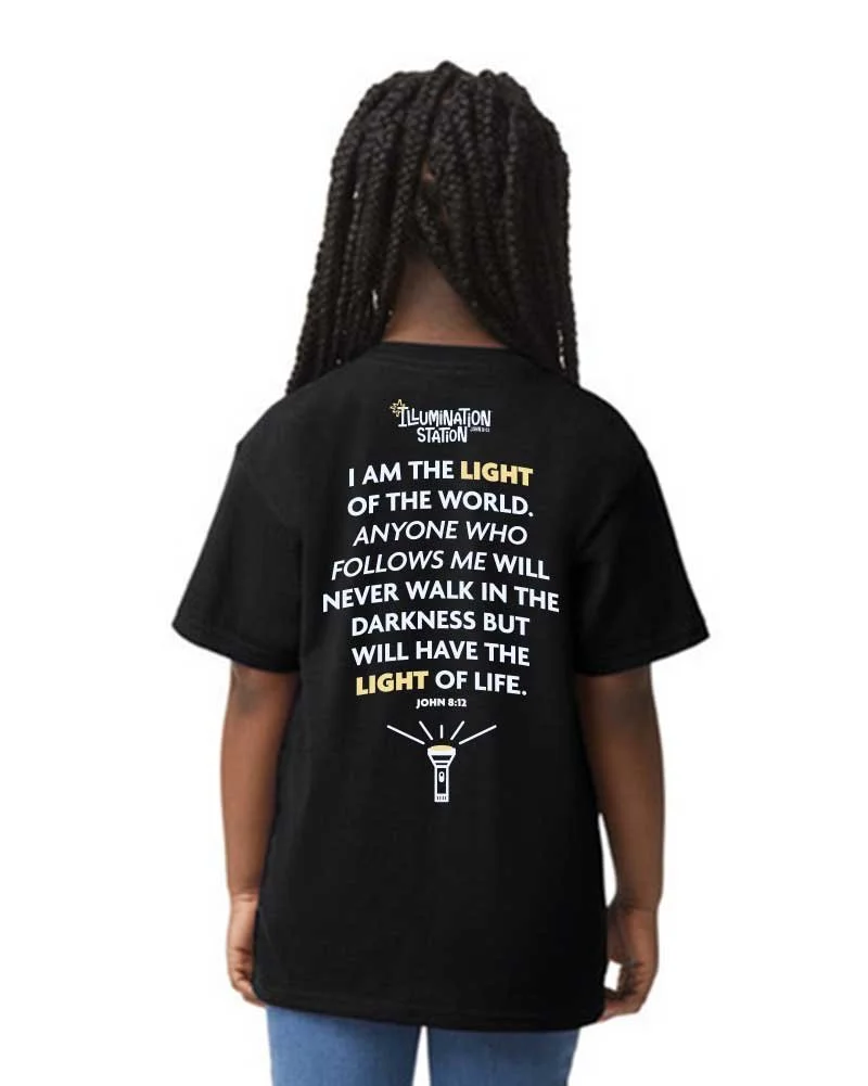 Back of a person wearing a black T-shirt with a Bible quote about light. The quote reads, "I am the light of the world. Anyone who follows me will never walk in the darkness but will have the light of life. John 8:12." The shirt also features a graphic of a flashlight.