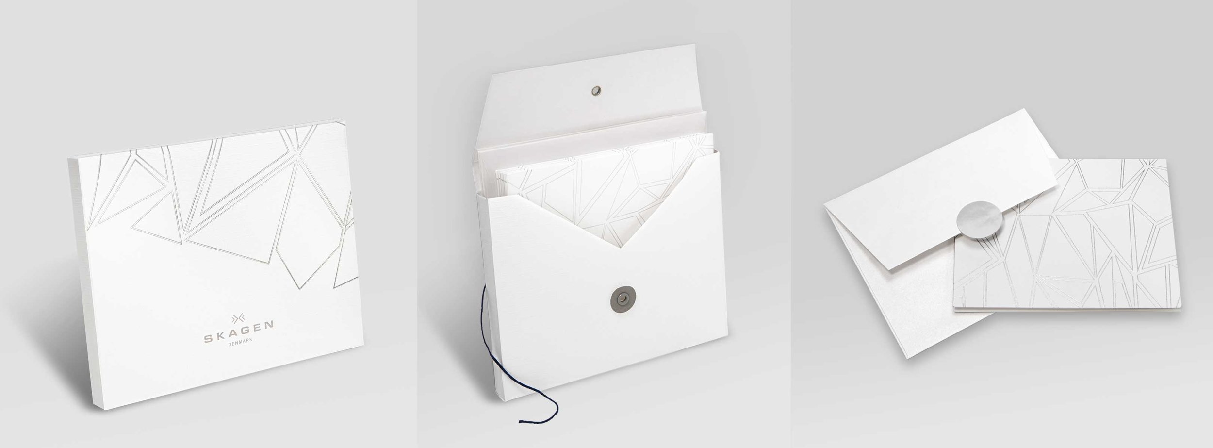 Custom card set design (concept, mechanicals, sample management through production). Silver foil debossed paper cards and packaging with white shimmery, metallic paper individual envelopes with silver metallic closure stickers.