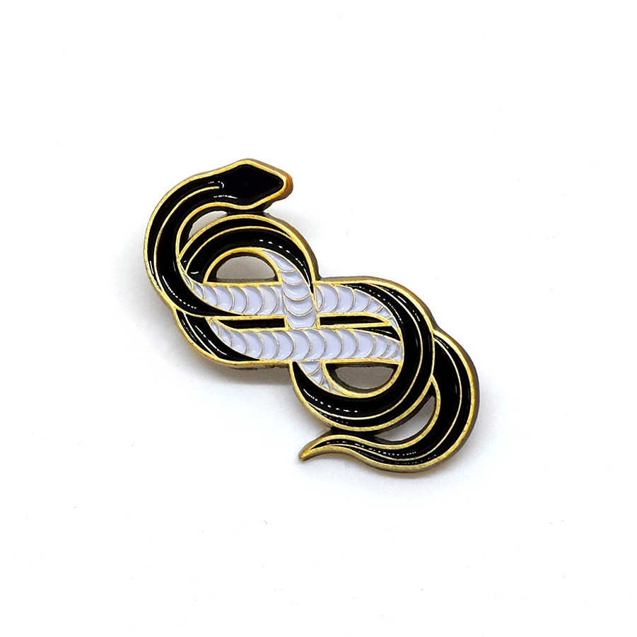 Custom black snake die-cast enamel pin, designed by Adam Vass of La Dispute, for Lost Lust Supply.